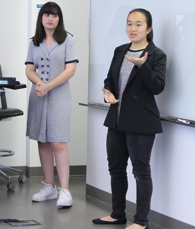 Two computer science students presenting in classroom
